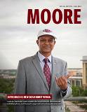 Moore Alumni Minizine cover featuring new Moore School dean, Rohit Verma, standing on the Moore School rooftop and wearing a Carolina Gamecocks baseball hat and tie. The Colonial Center can be seen in the distance.